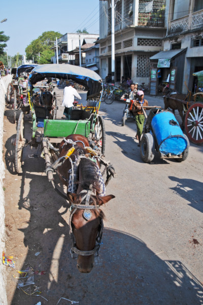 時代の移り変わりと共に乗り物も変化する。
乗り合い馬車からバイクタクシーへ。
ザガイン地域モンユワのチンドン河の船着きで客待ちをする乗合馬車。(ザガイン地域・モンユワ、2007年)(c) 筆者撮影